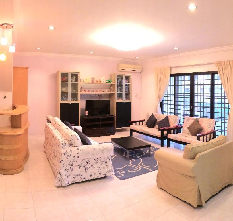 a large living room with couches and a fireplace at Golden Swan Sibu Homestay in Sibu