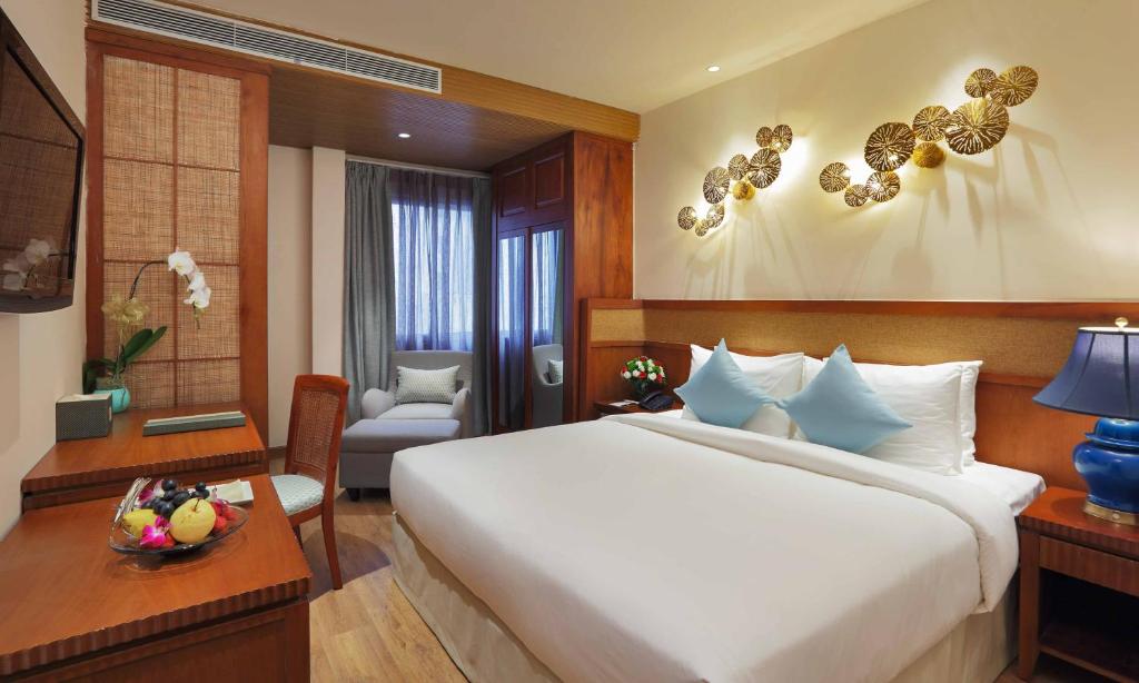 Giường trong phòng chung tại A&EM Art Hotel