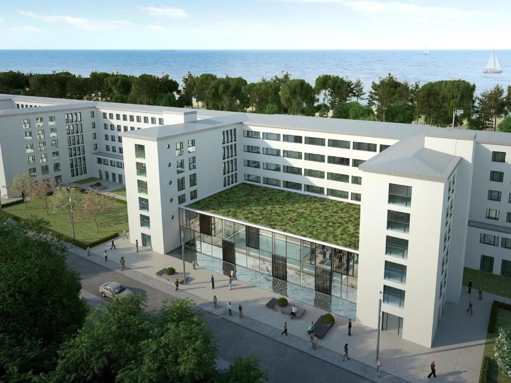 an architectural rendering of a building with a green roof at DORMERO Strandhotel Rügen in Binz