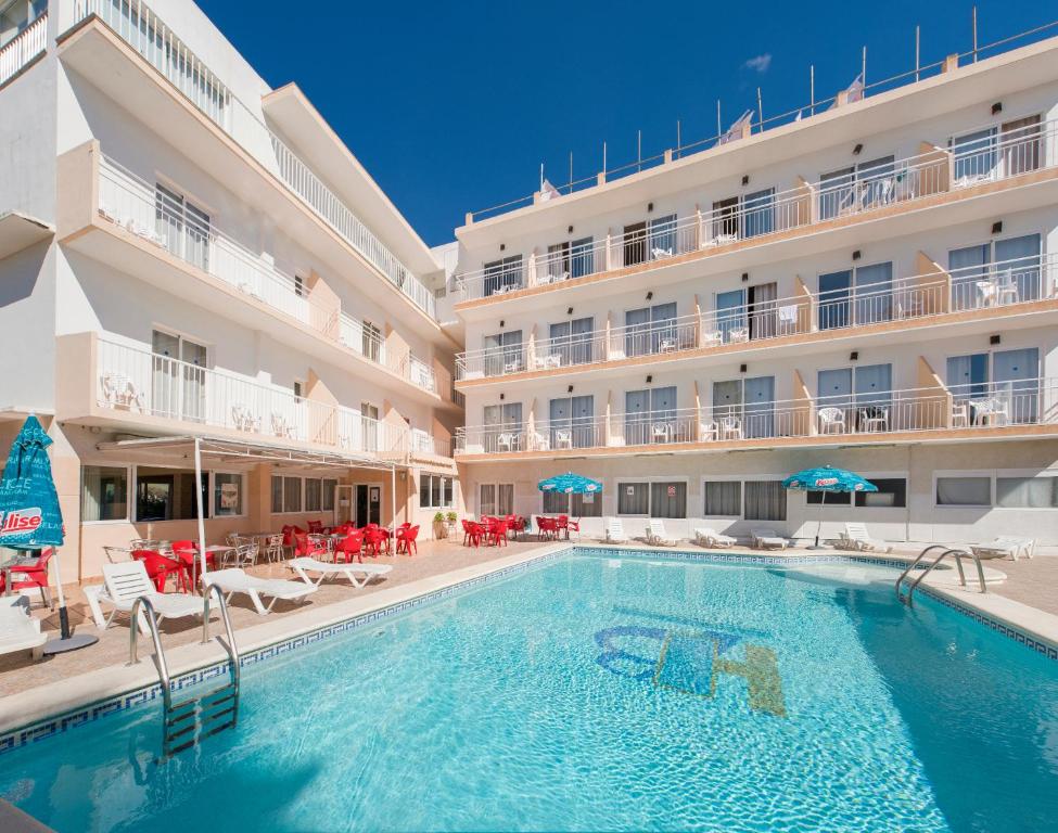 a swimming pool in front of a hotel at Hostal Anibal - AB Group in San Antonio