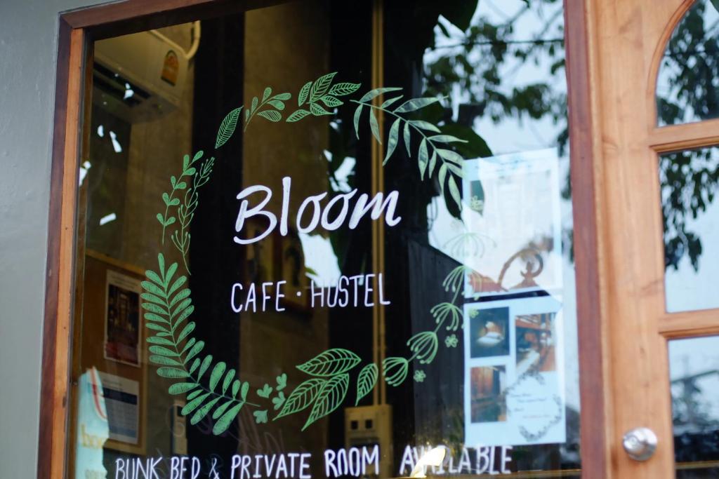 a sign on the door of a caferactical at Bloom Cafe & Hostel in Ko Lipe