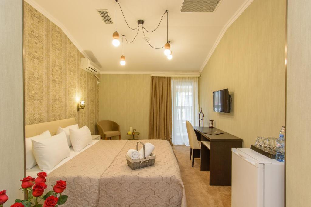 
a hotel room with a large bed and a large window at King David Hotel in Tbilisi City
