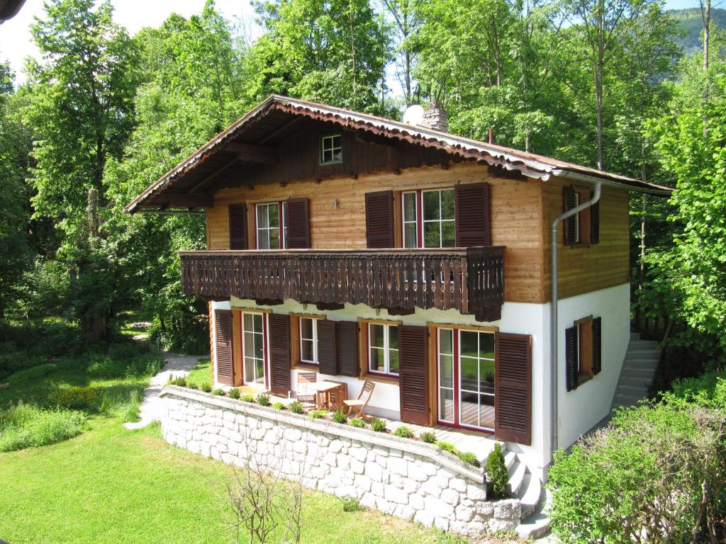 a log house in the woods with a yard at gartenhouse in St. Wolfgang