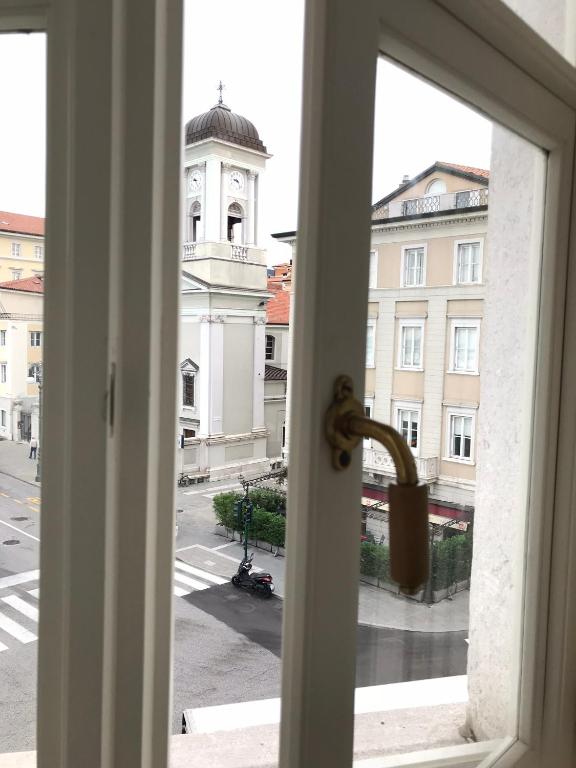 a window with a view of a building at Pep's Rooms by the sea in Trieste