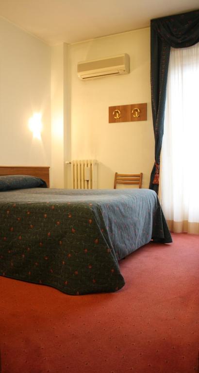 Postel nebo postele na pokoji v ubytování Hotel Arcobaleno