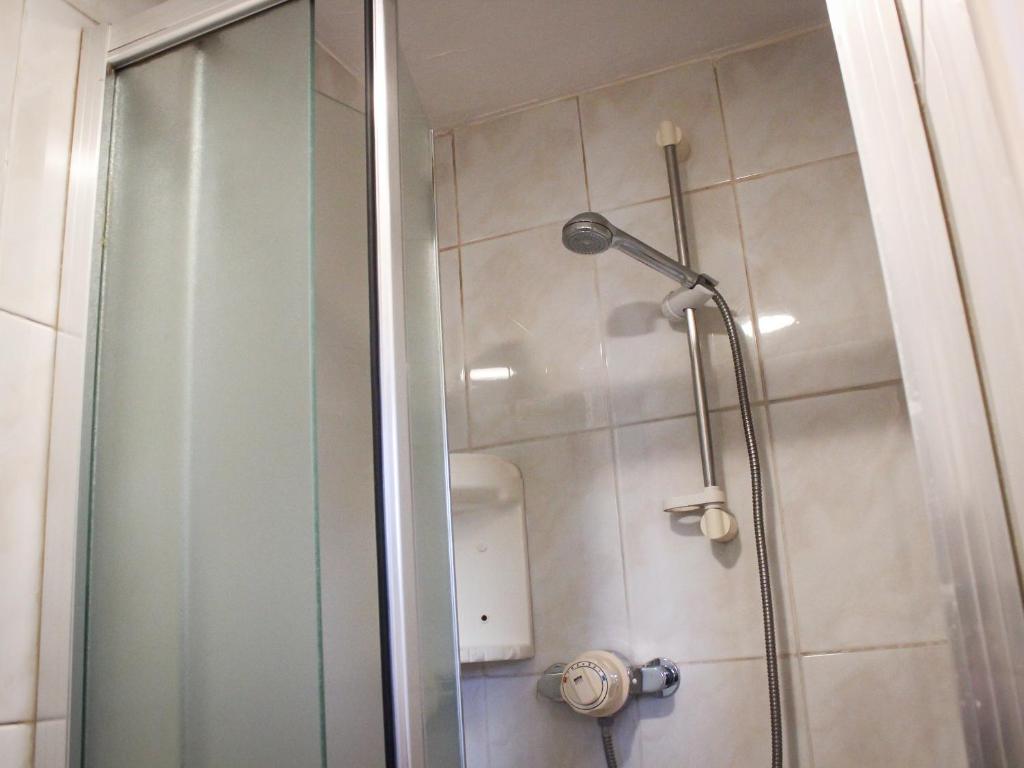 a shower with a glass door in a bathroom at Mary House 46 in Porthcawl
