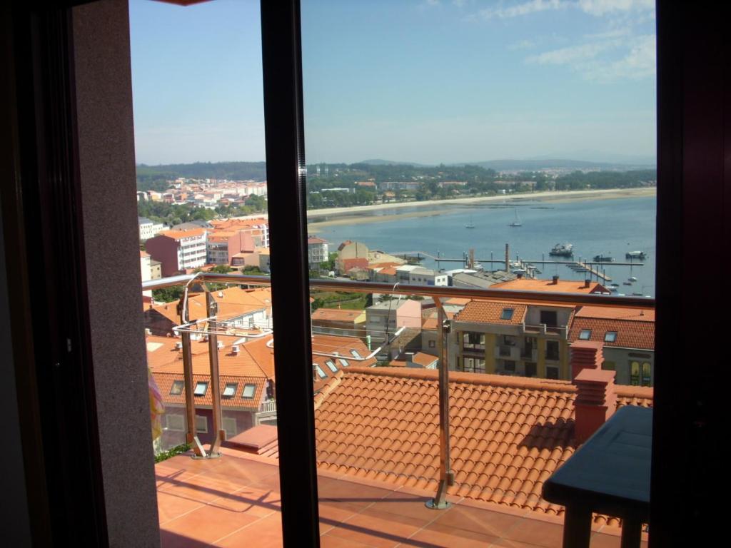 a view of a city from a window at Vivienda de uso turístico Vista Alegre in Boiro