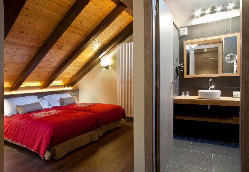 Postel nebo postele na pokoji v ubytování Hotel Boutique La Neu