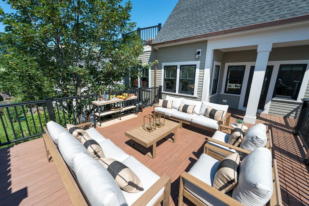 a patio with couches and tables on a house at The Newport Lofts - 595 Thames Street in Newport