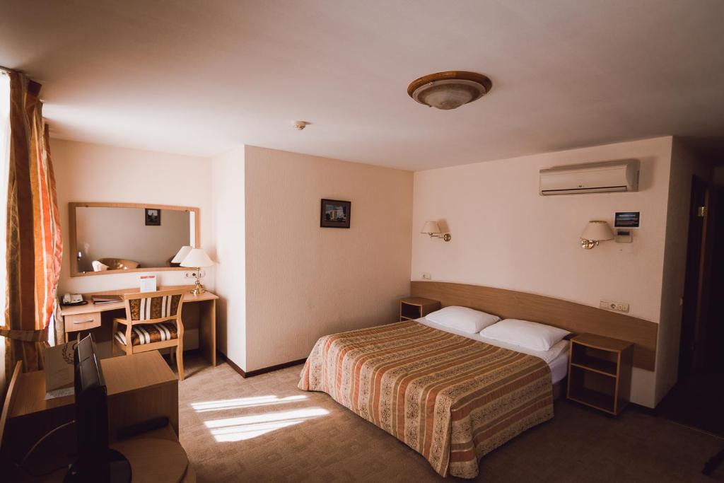 Postel nebo postele na pokoji v ubytování AMAKS Safar Hotel