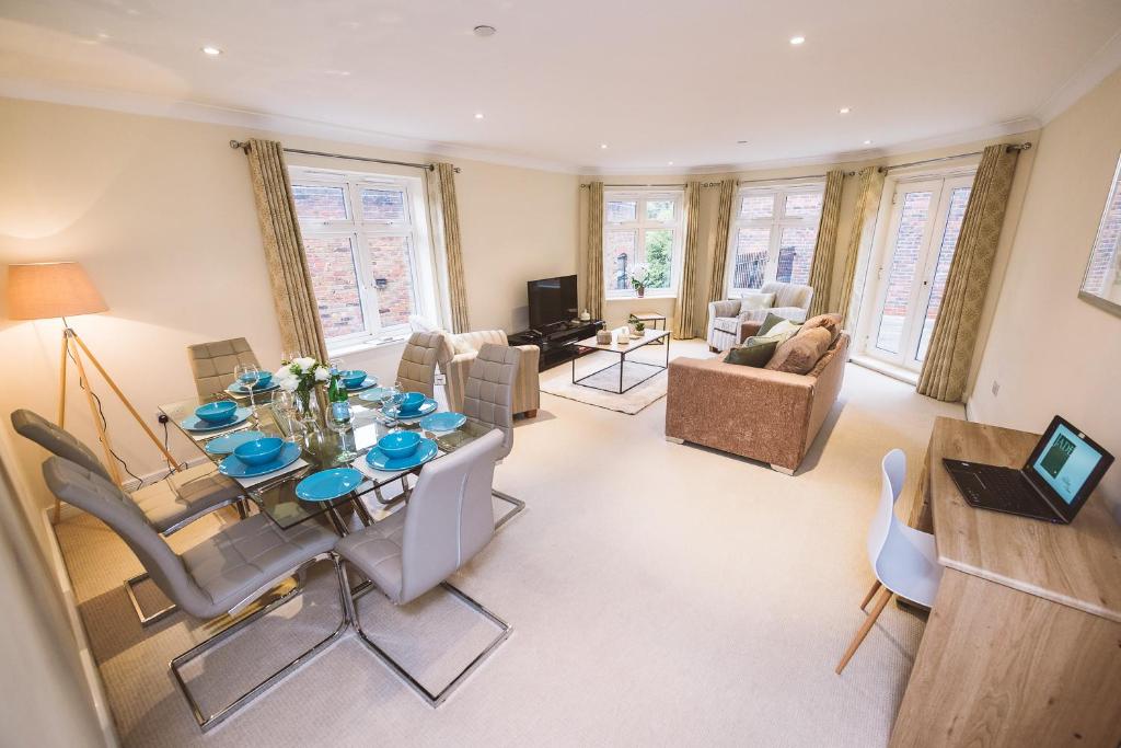 
a living room filled with furniture and a table at Jade - Royal Swan Quarter in Leatherhead
