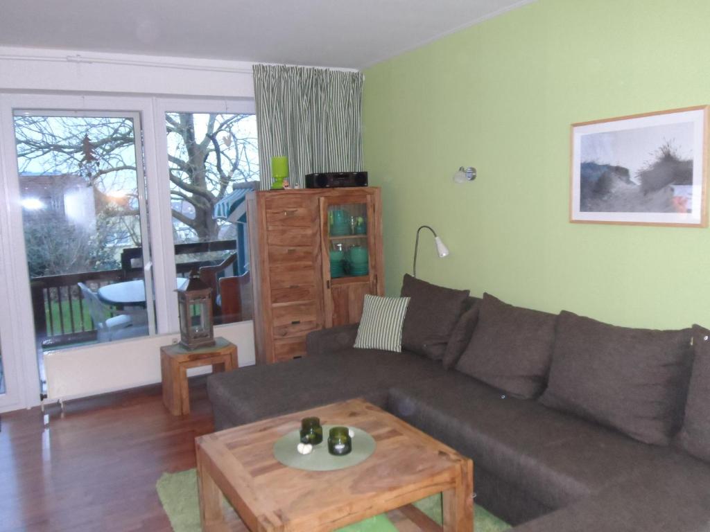 a living room with a couch and a coffee table at Ferienwohnung Ortlieb Laboe in Laboe