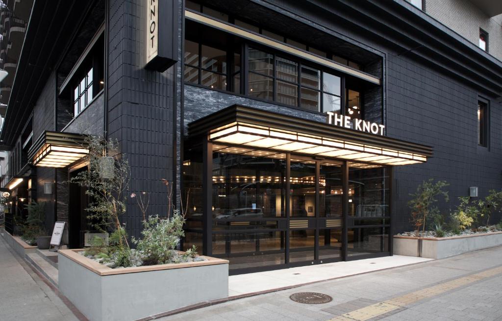 a black building with a sign that reads the knot at Hotel The Knot Yokohama in Yokohama