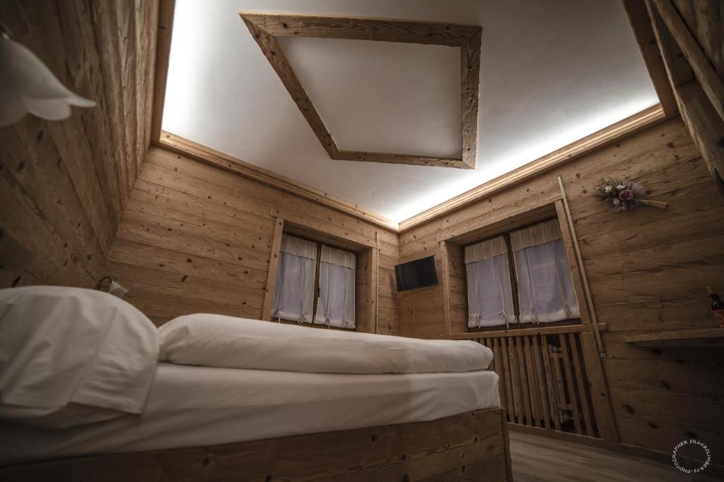 Letto o letti in una camera di B & B Le Riue