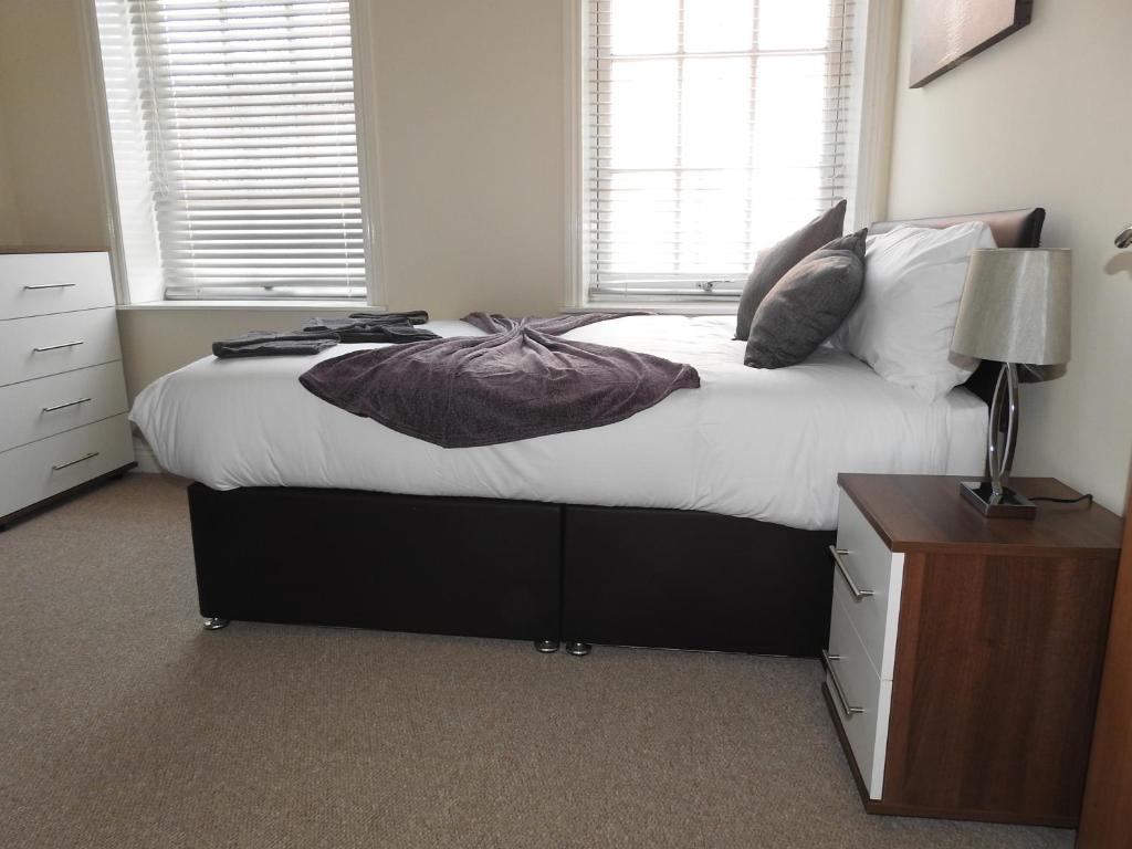 a bedroom with a large bed with white sheets and pillows at Parks Nest 1 in Hull