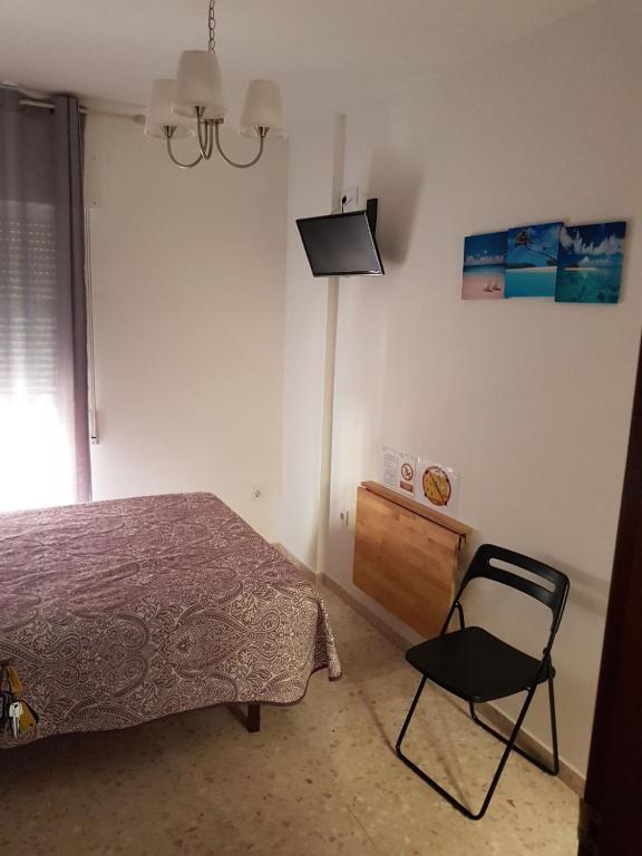 A bed or beds in a room at Hostal Tilos