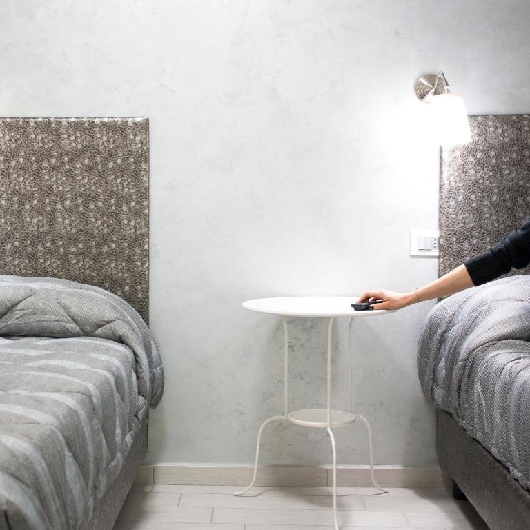 A bed or beds in a room at TIBUR STAR Guest House