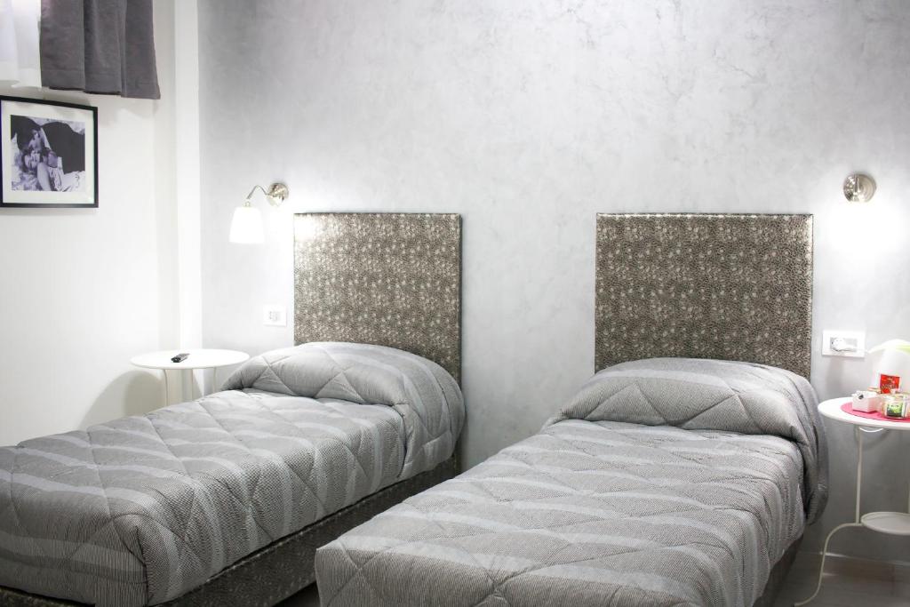 A bed or beds in a room at TIBUR STAR Guest House