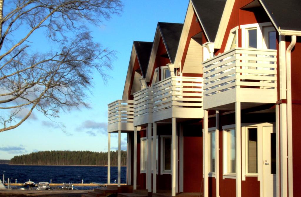 a house on the shore of a body of water at Marina Village in Saimaa Gardens in Imatra