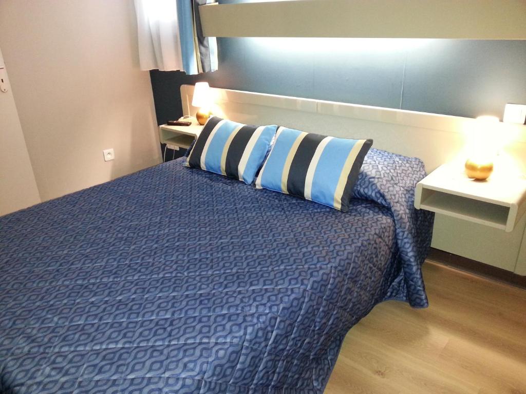 Postel nebo postele na pokoji v ubytování Hôtel Beach