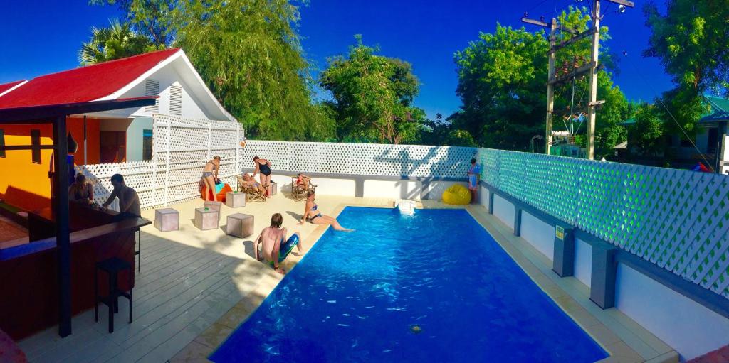 a group of people sitting around a swimming pool at Ostello Bello Bagan Pool in Bagan