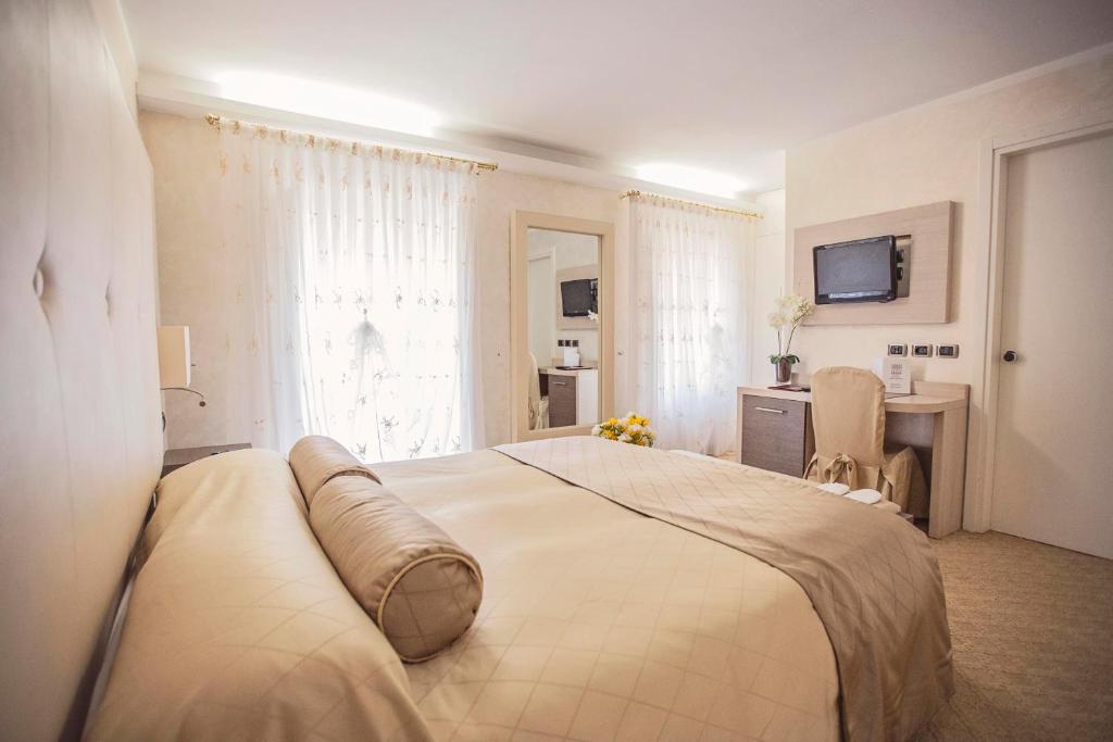 Postel nebo postele na pokoji v ubytování Hotel Trettenero