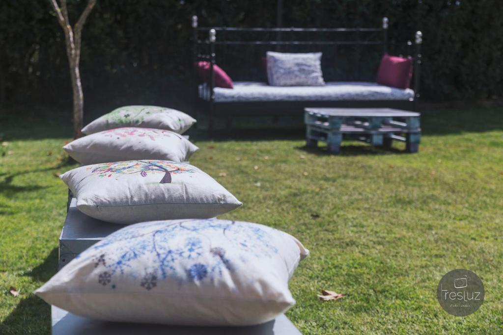 a row of pillows sitting on top of a yard at Hotel Sierra Quilama in San Miguel de Valero
