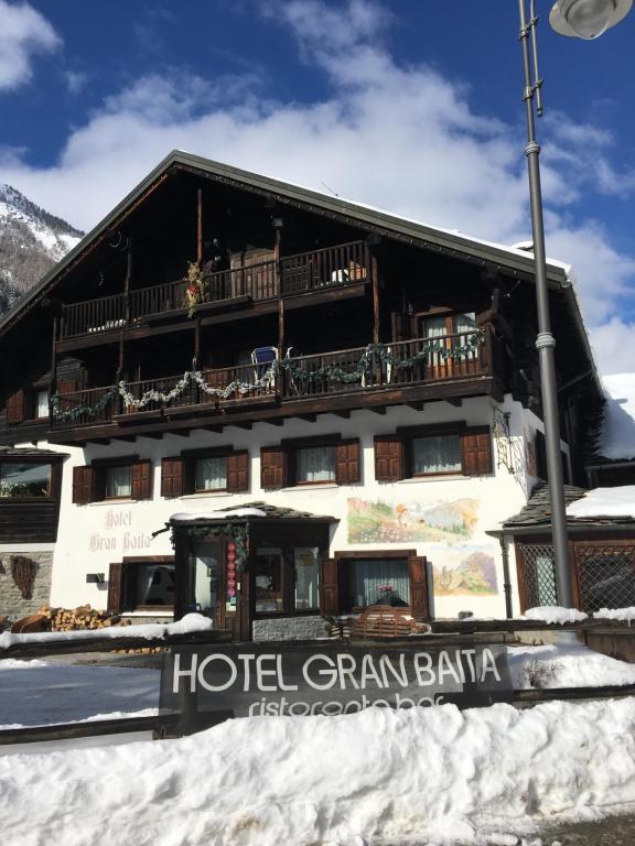 a hotel with a sign in front of a building at Hotel Gran Baita in Gressoney-Saint-Jean