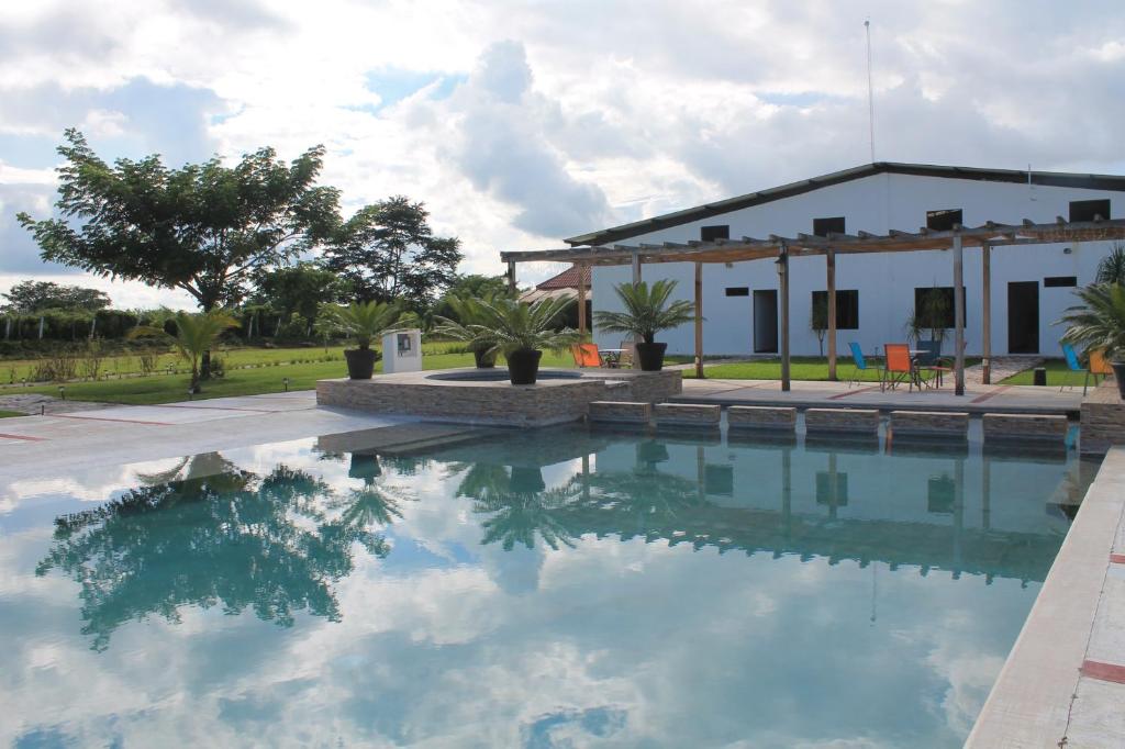 a swimming pool in front of a house at Real Primaveras Campestre in Escárcega