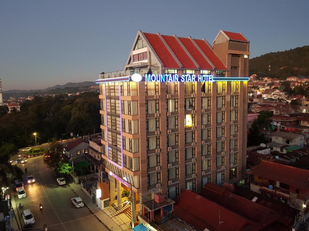 a building with a sign on top of it at Mountain Star Hotel in Taunggyi