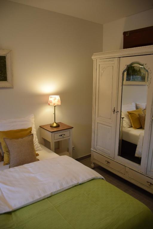 a bedroom with a bed and a dresser with a mirror at Hotel Apartments Belgium 3 - HAB 3 in Geel