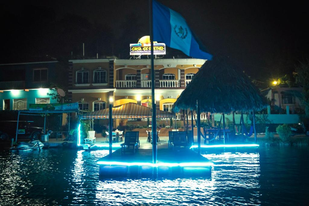 a building with a sign in the water at night at Hostal Casa de Grethel in Flores
