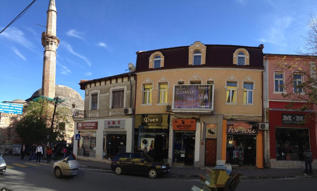 a street with a building with a mosque in the background at Rooms Sonata in Kyustendil