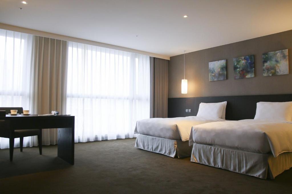 Postel nebo postele na pokoji v ubytování Platinum Hotel