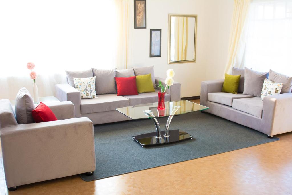 a living room with couches and a coffee table at Crystal Apartments in Lilongwe