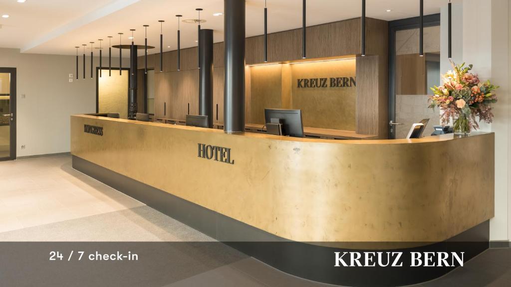a lobby of a hotel with a reception desk at Kreuz Bern Modern City Hotel in Bern