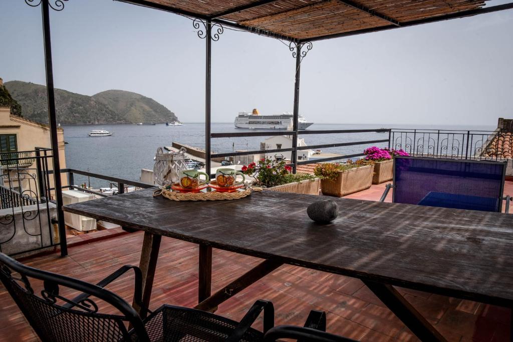a table on a balcony with a view of the water at Casa Giuliana in Lipari