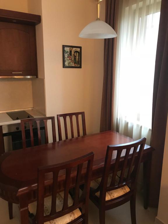 a dining room with a wooden table and chairs at Apartment in Downtown Complex Bansko in Bansko