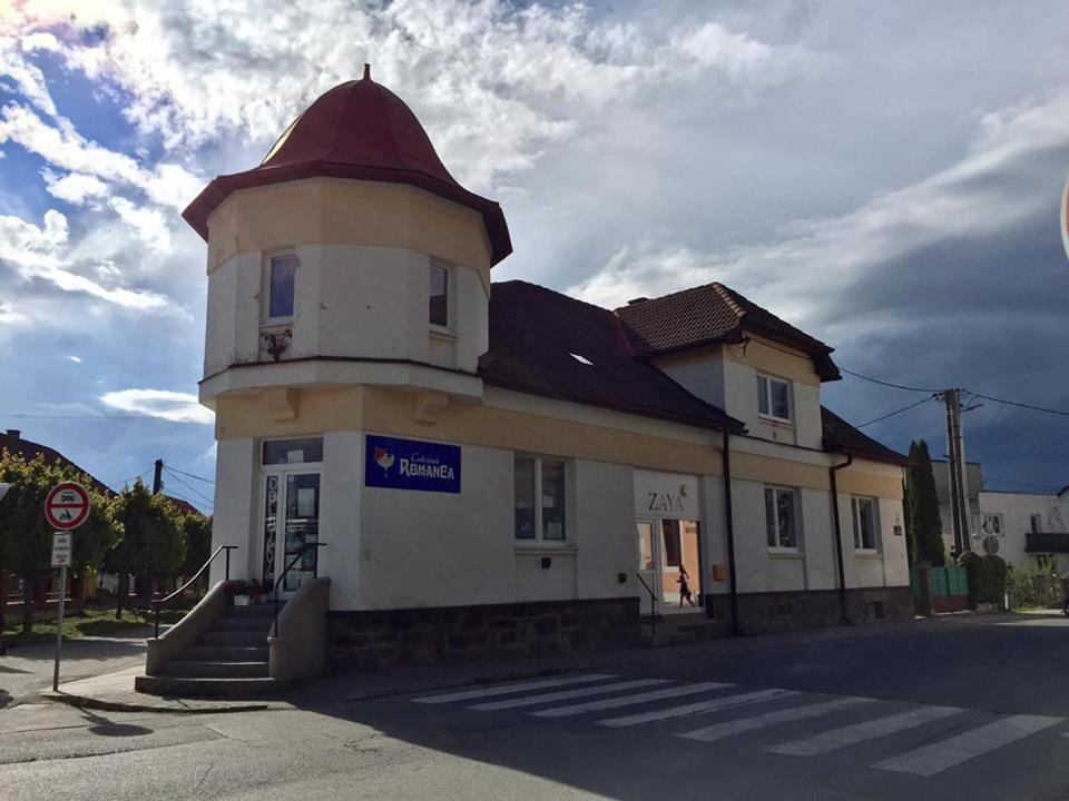 a building with a tower on the side of a street at Ubytovanie v súkromí in Turčianske Teplice