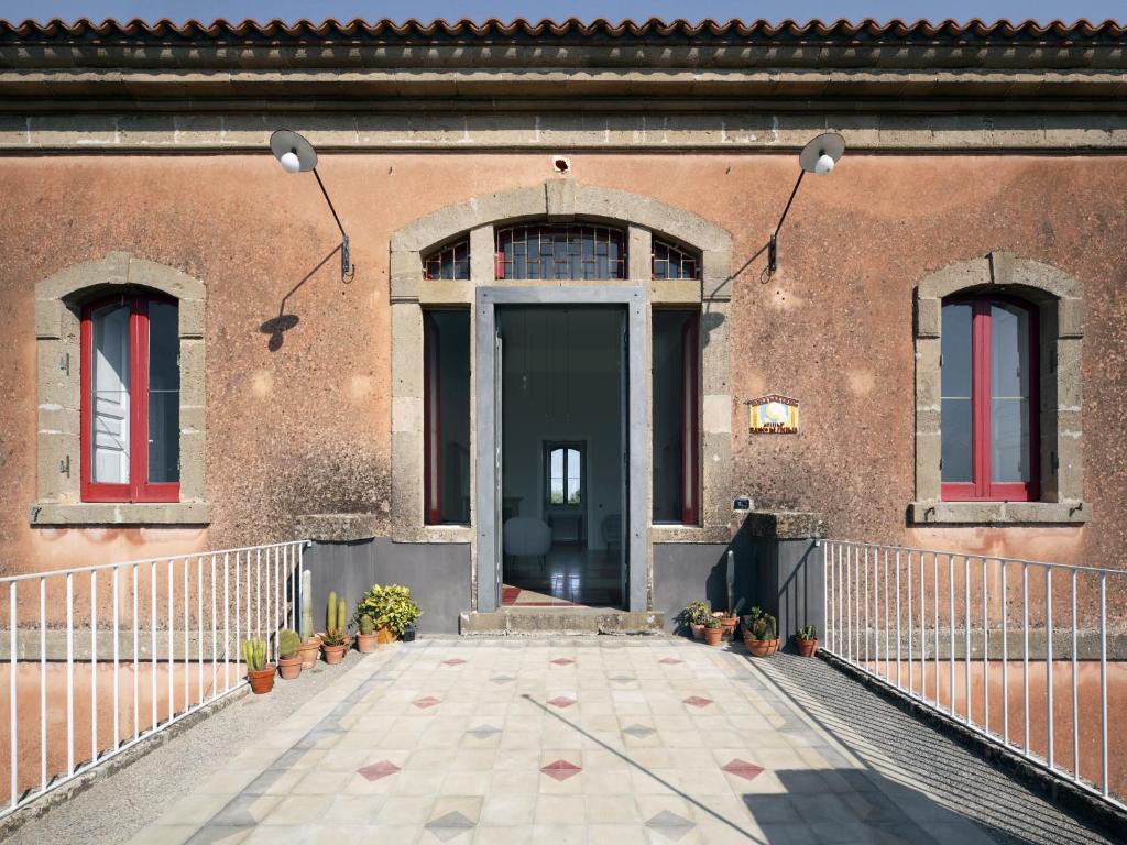 a door of a building with potted plants on it at Zahara in Carlentini