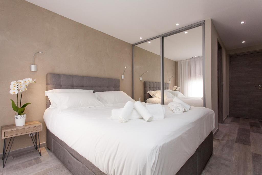 a bedroom with a large bed with white pillows at Palladium Palais des Festivals in Cannes