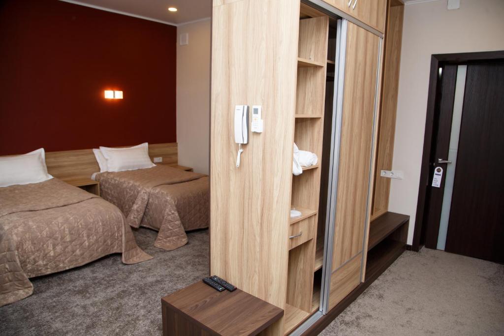 Postel nebo postele na pokoji v ubytování Lumarc Hotel