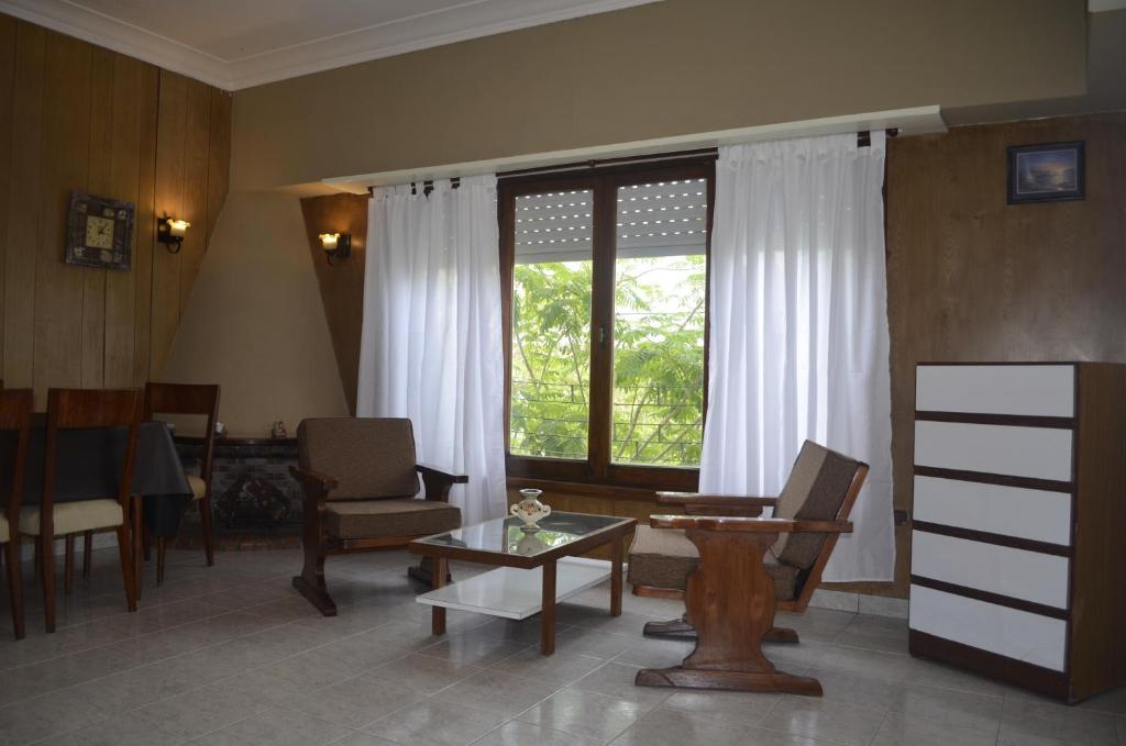 sala de estar con mesa, sillas y ventana en Apartamento Unico Miramar en Miramar