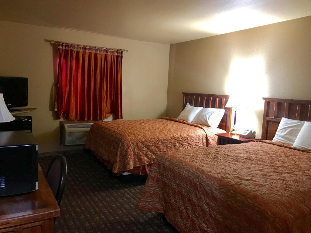 a hotel room with two beds and a window at Camino Real Hotel in Eagle Pass