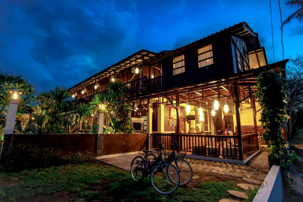 a house with bikes parked outside of it at night at Gili Buana in Gili Islands