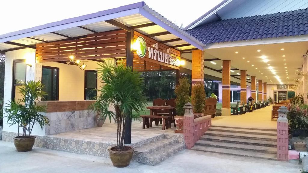 een restaurant met palmbomen voor de deur bij Three Bays Resort in Prachuap Khiri Khan