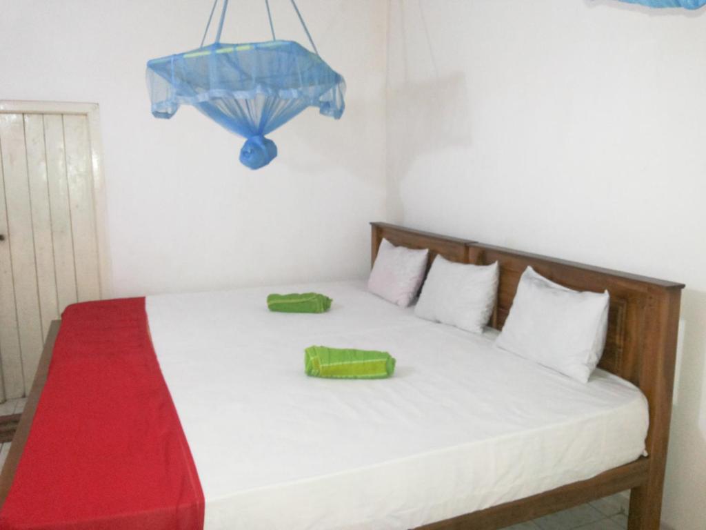 Postel nebo postele na pokoji v ubytování Jayaru Guest House