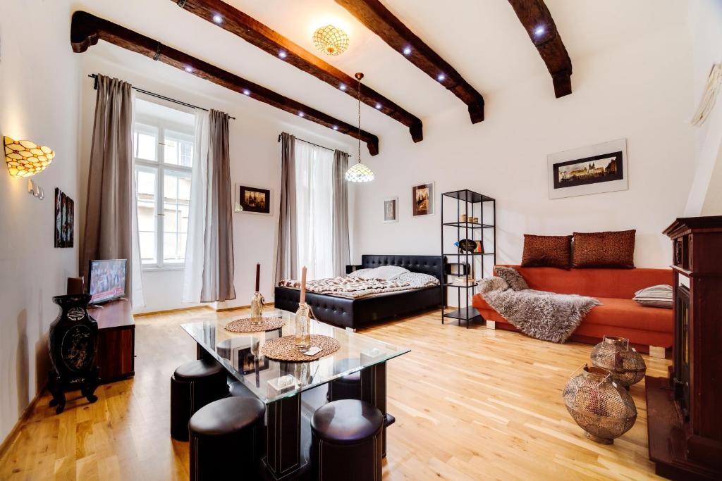 a living room with a couch and a table at Art Apartments Ruzova in Prague