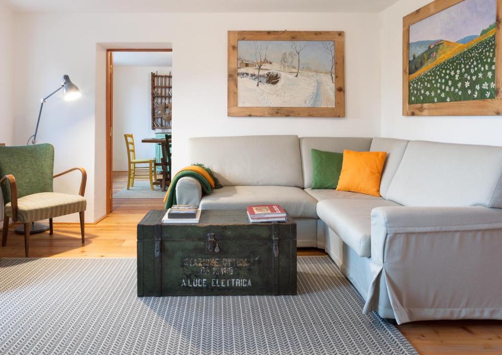 a living room with a couch and a table at COLVAGO COL DI LUNA – DOLOMITES NATIONAL PARK in Santa Giustina