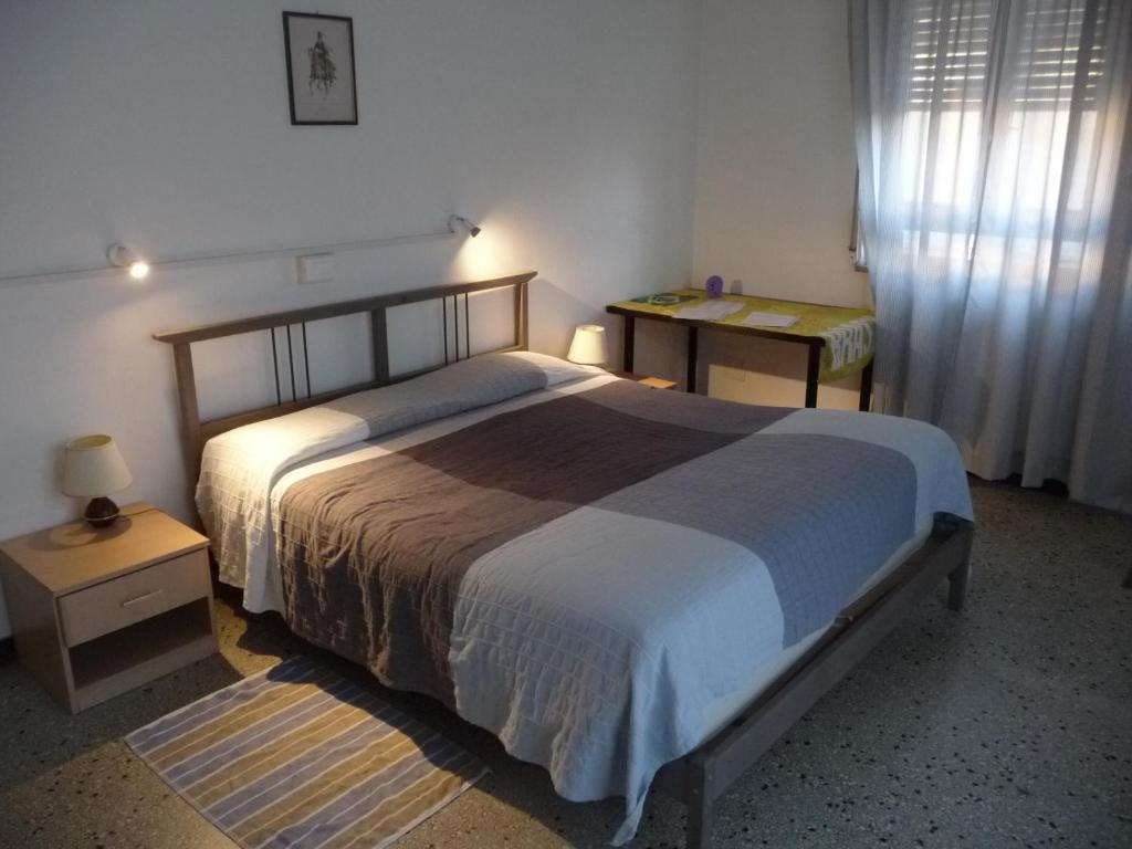 Appartamento Franca في ميستر: غرفة نوم بسرير وطاولة ونافذة